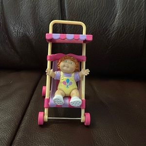 Vintage 1984 cabbage patch figure in stroller.